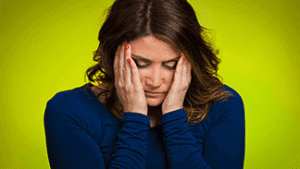 Mom with hands on the sides of her face stressed out