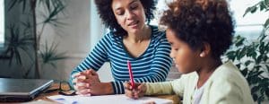 African american mom and daughter working on school work