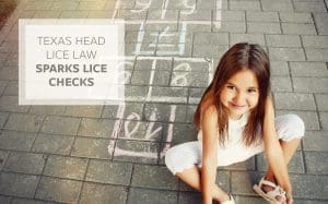 Little girl sitting next to a hopscotch
