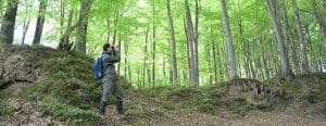 Man in the woods with binoculars