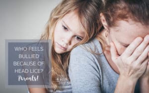 Little girl leaning on her mommy's shoulder.