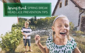 Brother spraying smiling sister with the hose