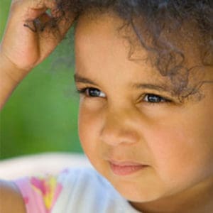 Cute little girl itching her head